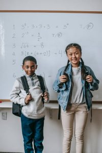 Kids standing in front of a white board