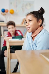 A girl in a class smiling